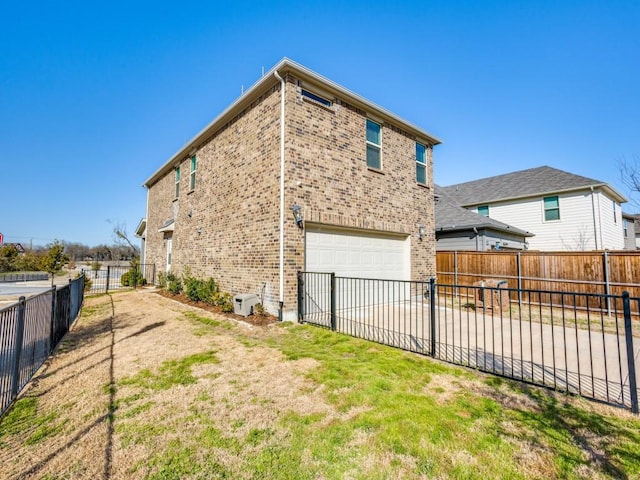 back of house with a garage, brick siding, and fence