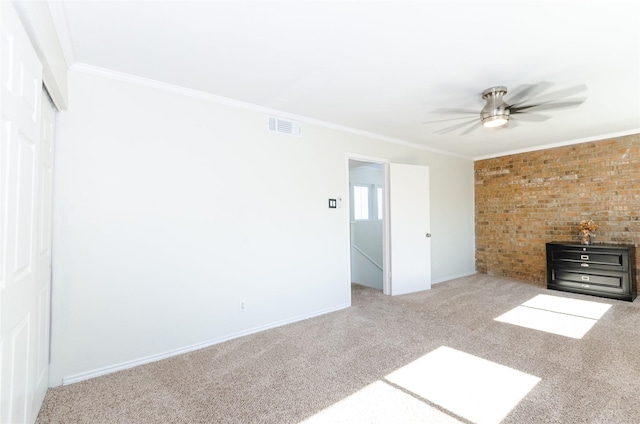 unfurnished living room featuring crown molding, light colored carpet, visible vents, a ceiling fan, and baseboards