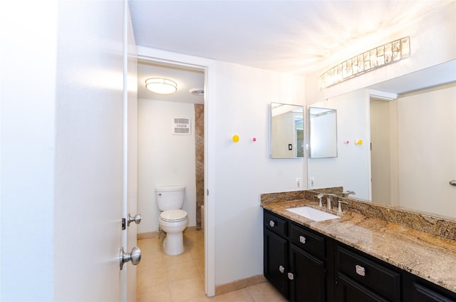 bathroom with visible vents, toilet, vanity, and tile patterned floors