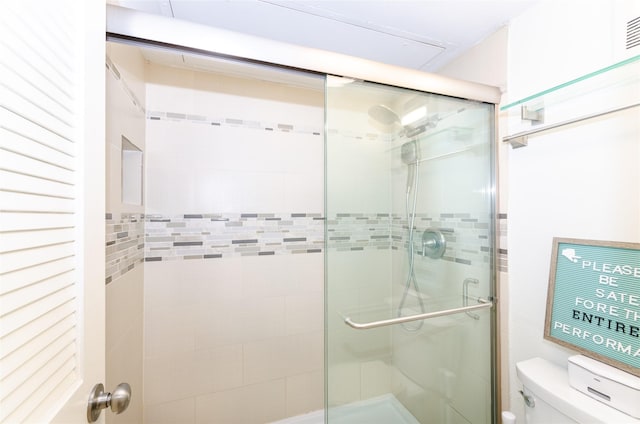 bathroom with a stall shower, visible vents, and toilet