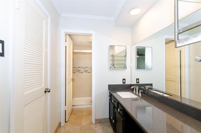 bathroom featuring a stall shower, tile patterned flooring, crown molding, and vanity