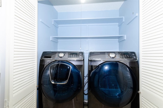 washroom featuring washer and dryer and laundry area