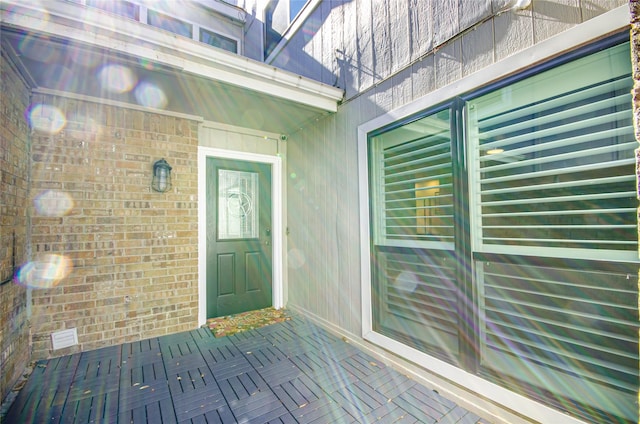 property entrance featuring brick siding