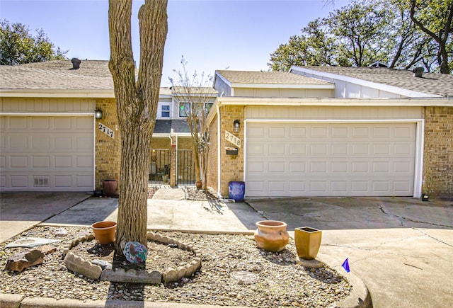 view of front of home featuring a garage, brick siding, and driveway