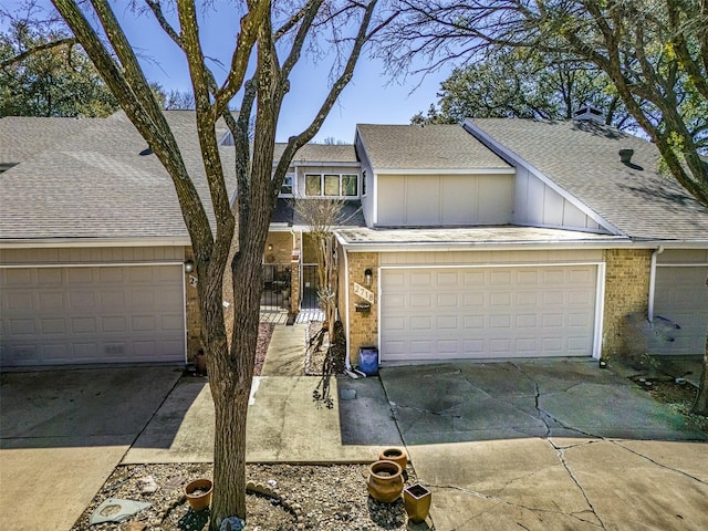 view of front facade featuring board and batten siding, concrete driveway, a shingled roof, and a garage