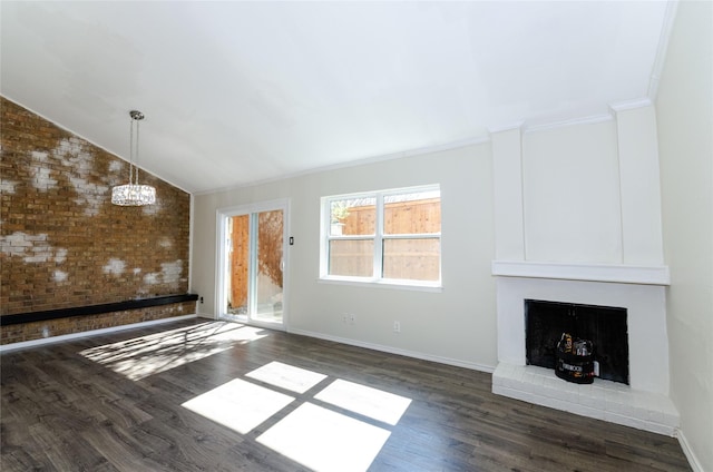 unfurnished living room featuring lofted ceiling, a large fireplace, brick wall, dark wood-type flooring, and baseboards