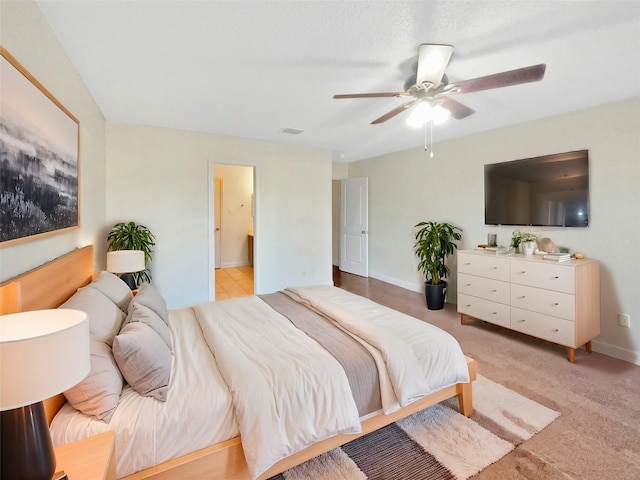 bedroom featuring light colored carpet, visible vents, ceiling fan, and baseboards