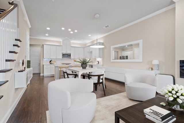 living room with stairs, recessed lighting, crown molding, and wood finished floors