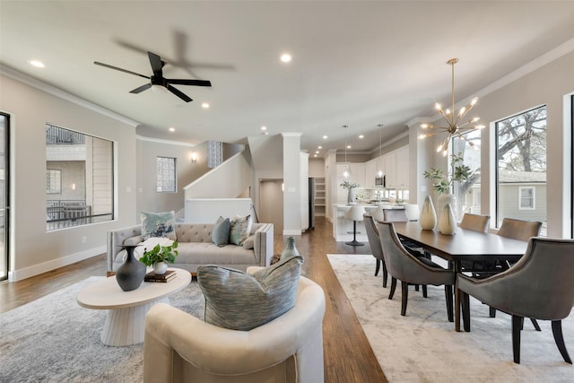 living area featuring recessed lighting, light wood-type flooring, and crown molding