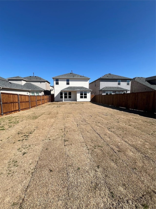 back of house featuring a fenced backyard