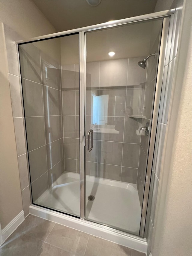 bathroom featuring a shower stall and tile patterned floors