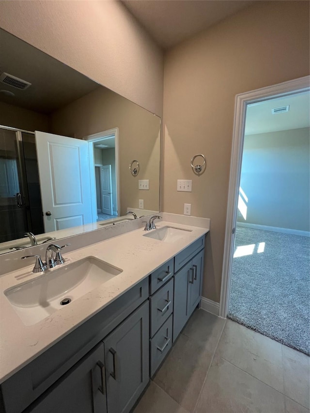 full bath featuring visible vents, a sink, and double vanity