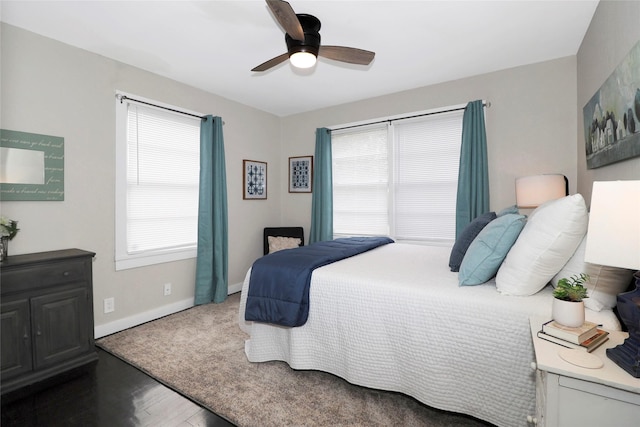 bedroom featuring ceiling fan, wood finished floors, and baseboards