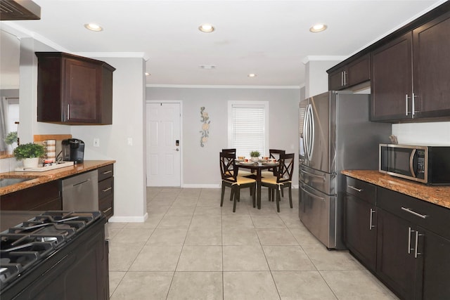 kitchen featuring light stone countertops, stainless steel appliances, crown molding, a sink, and light tile patterned flooring