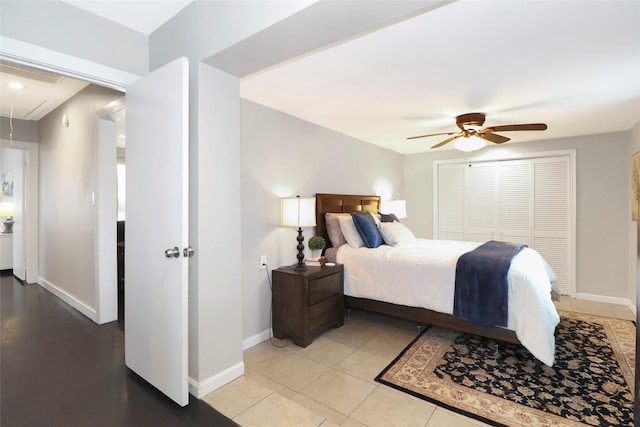 bedroom with light tile patterned floors, attic access, baseboards, and ceiling fan