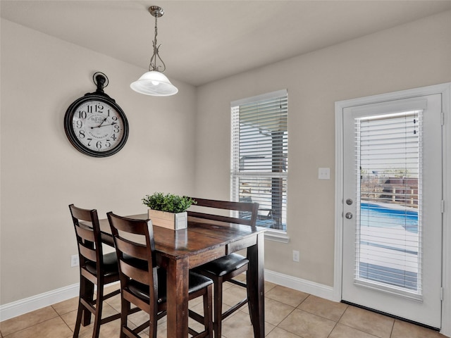 dining room with light tile patterned floors and baseboards