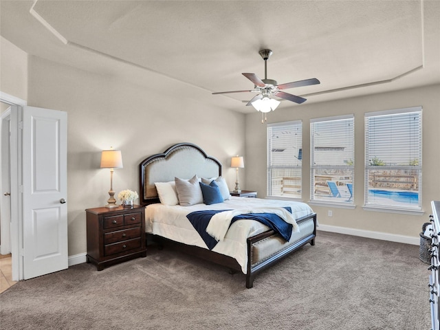 carpeted bedroom with a ceiling fan and baseboards