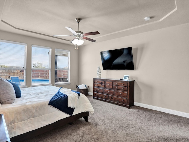 carpeted bedroom with baseboards and a ceiling fan