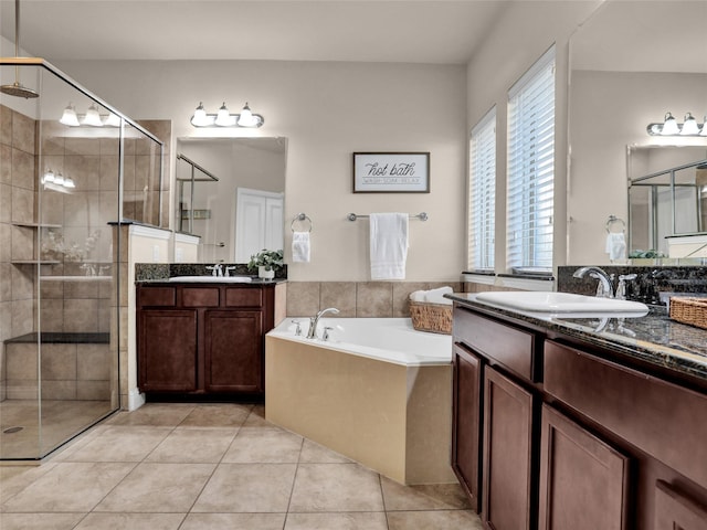 full bath featuring a garden tub, a sink, and a shower stall