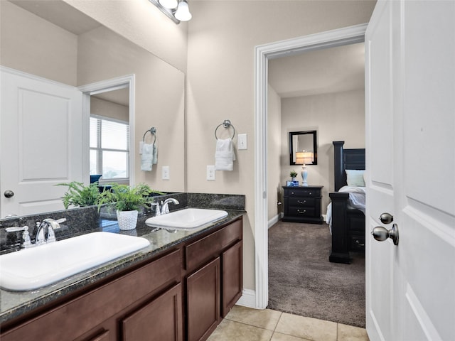 bathroom with double vanity, ensuite bath, tile patterned flooring, and a sink