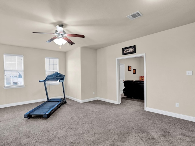 workout room featuring a ceiling fan, carpet, visible vents, and baseboards