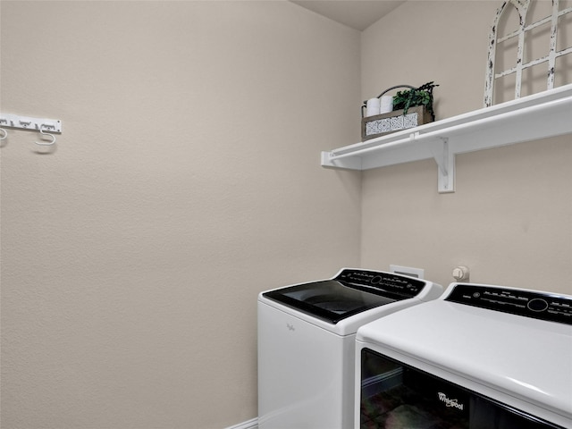 washroom featuring laundry area and separate washer and dryer