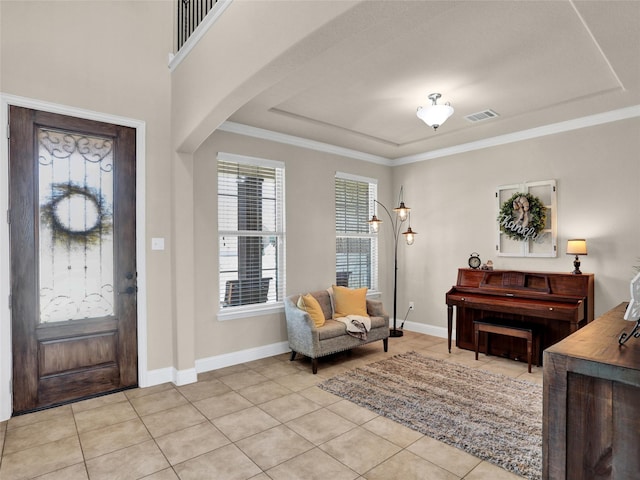 entrance foyer featuring arched walkways, light tile patterned floors, visible vents, and baseboards