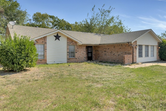 ranch-style house featuring a shingled roof, brick siding, and a front lawn