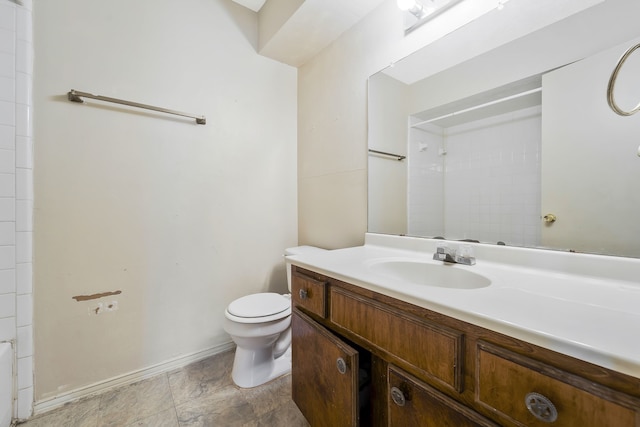 full bath featuring walk in shower, vanity, toilet, and baseboards