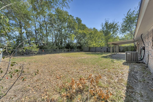 view of yard with a patio area, a fenced backyard, and central AC