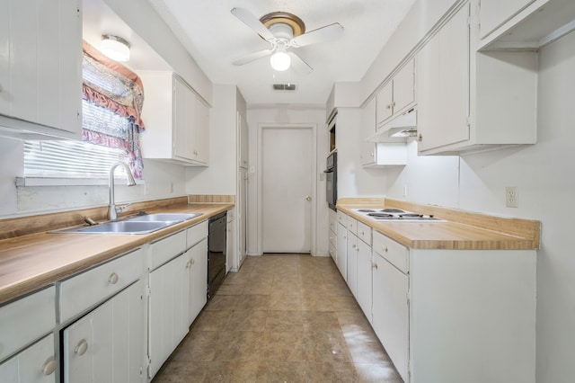 kitchen with light countertops, white cabinets, a sink, and under cabinet range hood