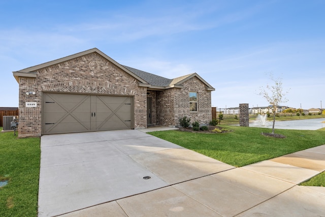 ranch-style house featuring driveway, brick siding, an attached garage, and a front yard