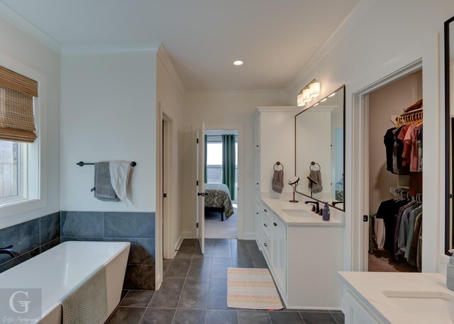 ensuite bathroom with crown molding, connected bathroom, vanity, and a freestanding bath