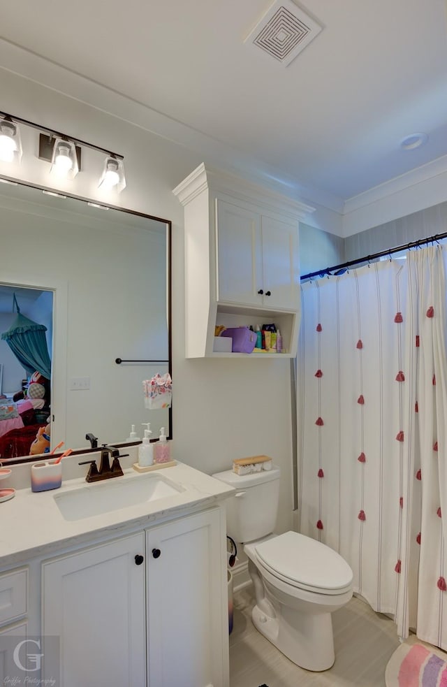 bathroom featuring visible vents, a shower with shower curtain, toilet, ornamental molding, and vanity