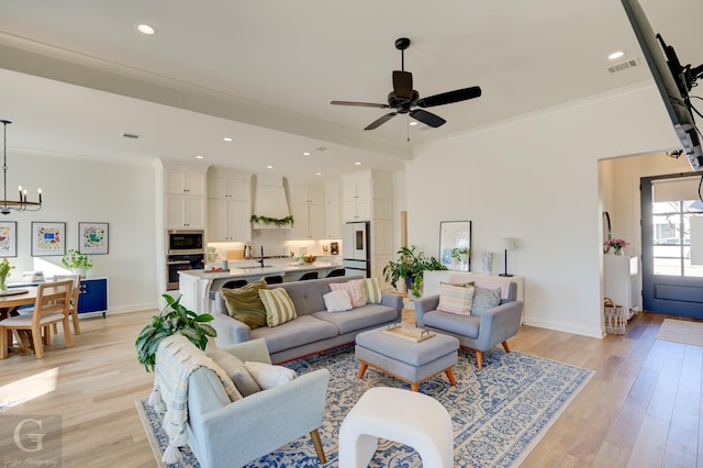 living room with recessed lighting, visible vents, baseboards, ornamental molding, and light wood finished floors