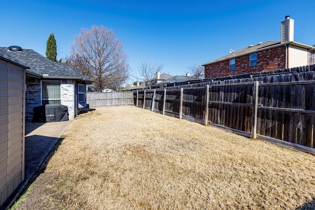 view of yard with a fenced backyard