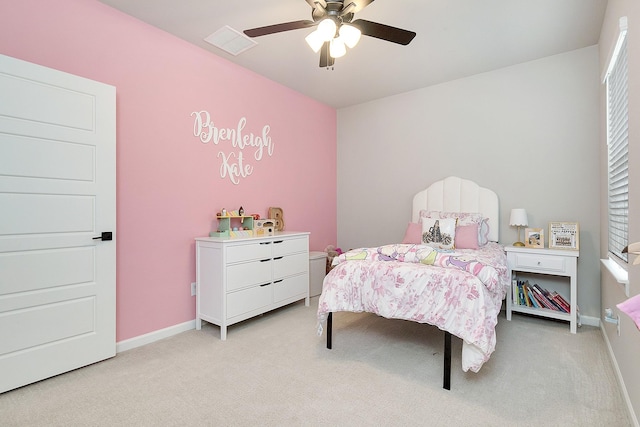 bedroom with a ceiling fan, visible vents, light carpet, and baseboards