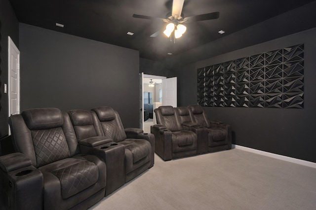 home theater room with ceiling fan, baseboards, and carpet flooring