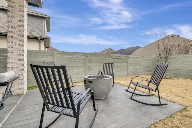 view of patio / terrace featuring a fenced backyard and a fire pit