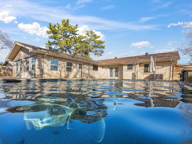 outdoor pool with french doors and fence