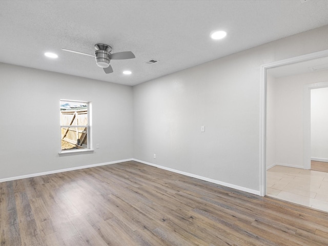 empty room with recessed lighting, visible vents, and wood finished floors