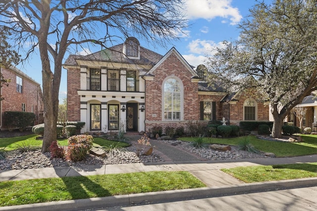 view of front of property with a balcony and brick siding