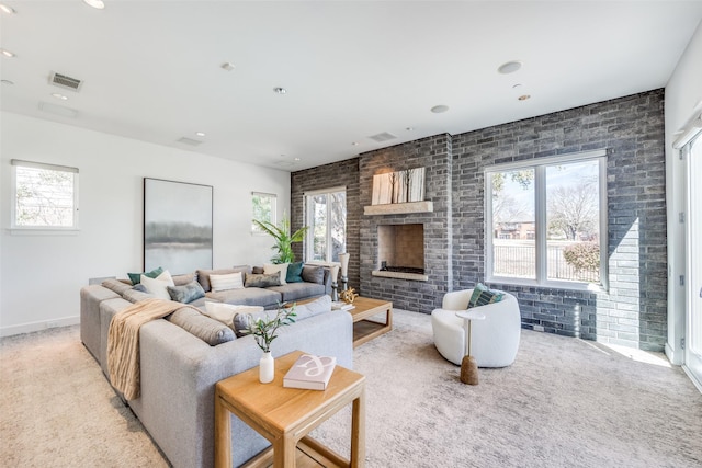 6007 Club Oaks Dr, Dallas, TX 75248 - carpeted living room with healthy amount of natural light, brick wall, a fireplace, baseboards, and recessed lighting
