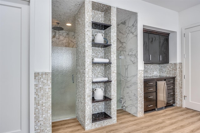 6007 Club Oaks Dr, Dallas, TX 75248 - bathroom featuring tile walls, a marble finish shower, wood finished floors, and vanity