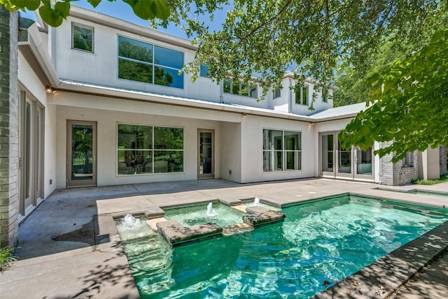 6007 Club Oaks Dr, Dallas, TX 75248 - back of property with stucco siding, a patio area, a pool with connected hot tub, and metal roof