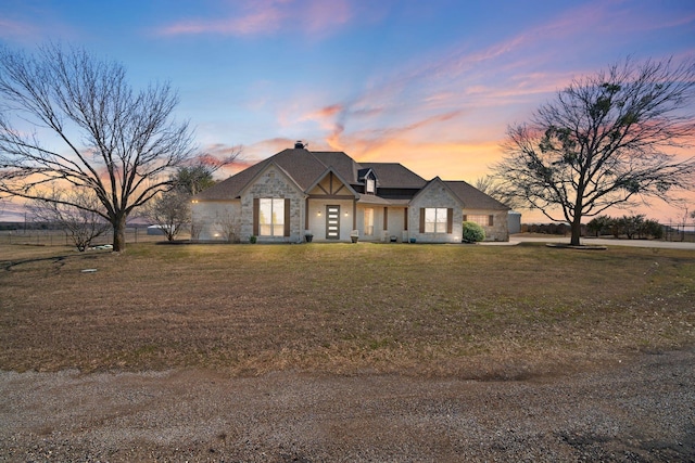 view of front of property featuring stone siding and a front yard