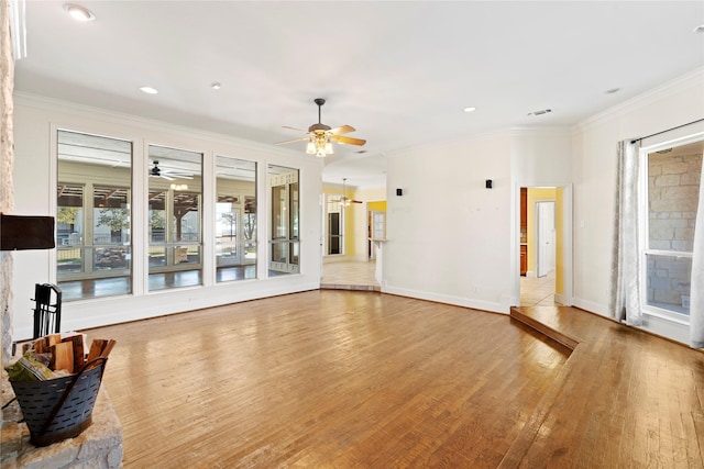 living room featuring ceiling fan, recessed lighting, baseboards, ornamental molding, and light wood finished floors