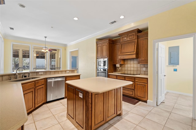 kitchen with stainless steel appliances, a sink, light countertops, electric panel, and decorative light fixtures