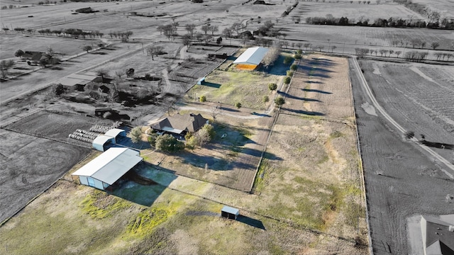 birds eye view of property with a rural view