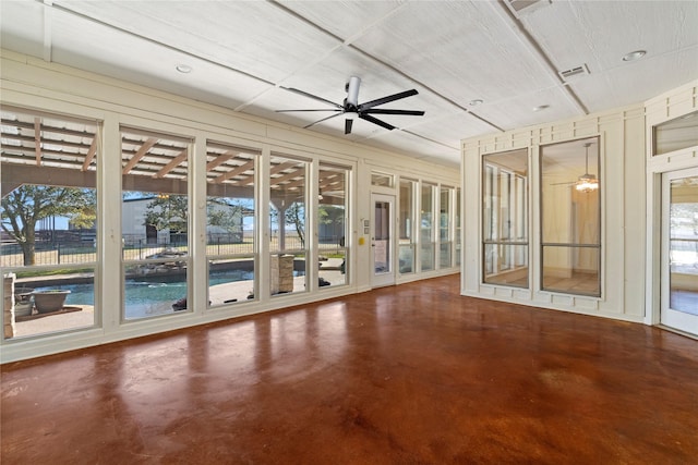 unfurnished sunroom with visible vents and a ceiling fan